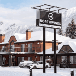 Northwind Hotel with snow background #MoraineLakeShuttle #LakeLouiseTour #BanffExplorer #ExploreBanff #MoraineLakeAccess